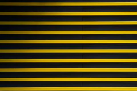 Modern rhythmic pattern sliding yellow metal blinds for protection Stock Photos