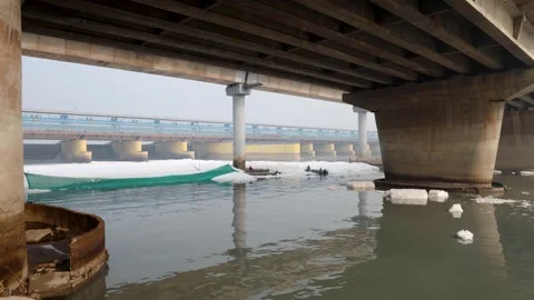 Modern Road Bridge Spanning Contaminated River with Toxic Foam at misty morni Stock Footage 295017545
