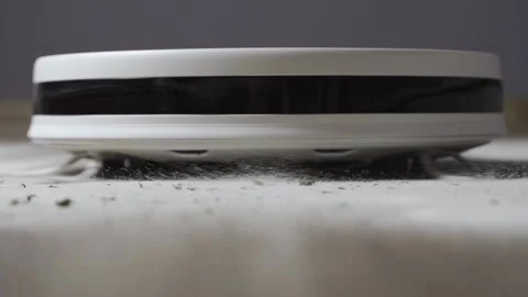 Modern robot vacuum cleaner working in the house kitchen Video stock 143910096