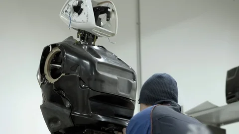 Modern Robotic Technologies. The engineer creates a modern robot or android Stock Footage 101367370