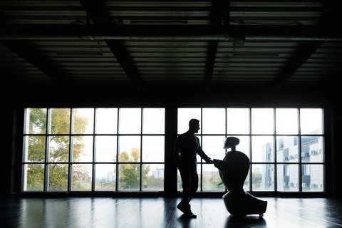 Modern Robotic Technologies. A man communicates with a robot, presses a plastic Stock Photos