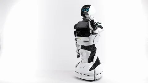 Modern Robotic Technologies. Robot in the bright studio. Android raises and Video stock 101387914