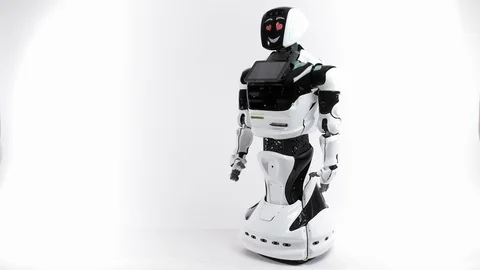 Modern Robotic Technologies. Robot in the bright studio. Android raises and Video stock 101389586