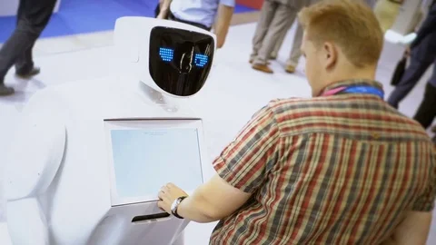 Modern Robotic Technologies. The robot looks at the camera at the person. The Stock Footage 82607637