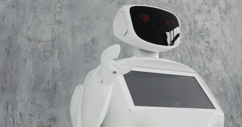 Modern Robotic Technologies. The robot looks at the camera at the person. The Stock Footage 97967480