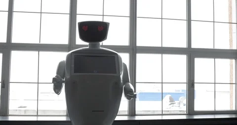 Modern Robotic Technologies. The robot looks at the camera at the person. The Stock-Footage 97968023