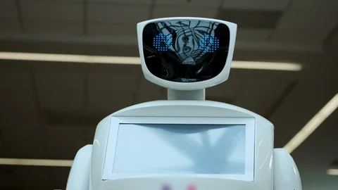 Modern Robotic Technologies. The robot looks at the camera at the person Video stock 99485728