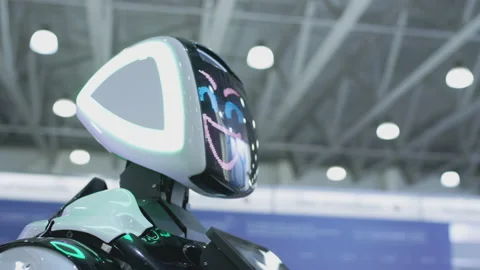 Modern Robotic Technologies. The robot looks at the camera at the person. The Video stock 143964746