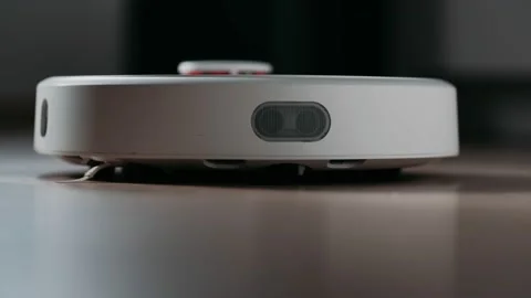 Modern robotic vacuum cleaner cleans the floor. Housekeeping. Stock Footage 165724481