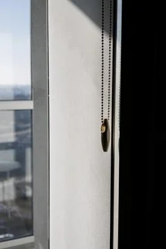 Modern roller blind with a plastic beaded chain controller Stock Photos