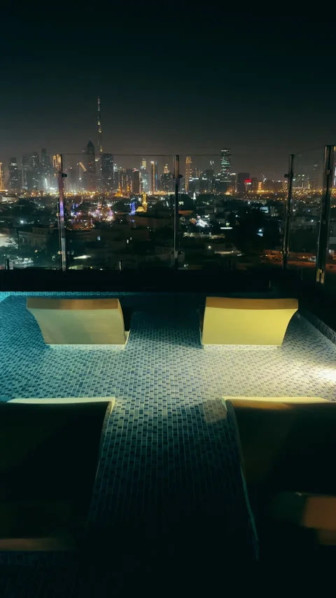 Modern rooftop infinity pool overlooking a vibrant Dubai city downtown skylin Stock Footage 315795320