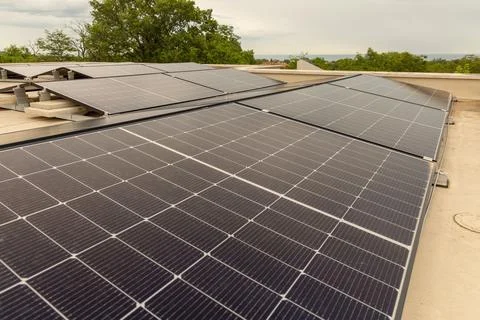 Modern rooftop solar panels generating clean renewable energy on a sunny da.. Stock Photos