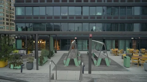 A modern rooftop space with a delightful swing set and comfortable outdoor Video stock 295076564