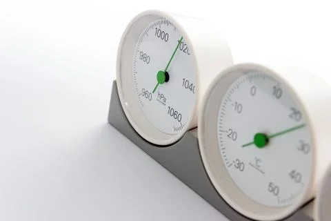 Modern, round barometer, thermometer, hygrometer. Analog device for measuring Stock Photos