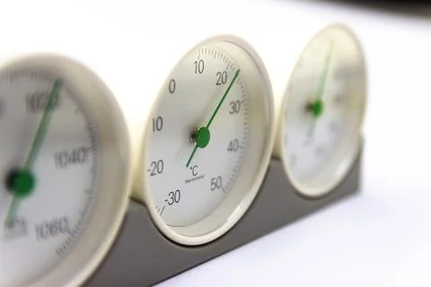 Modern, round barometer, thermometer, hygrometer. Analog device for measuring Stock Photos