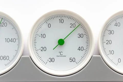 Modern, round barometer, thermometer, hygrometer. Analog device for measuring Stock Photos