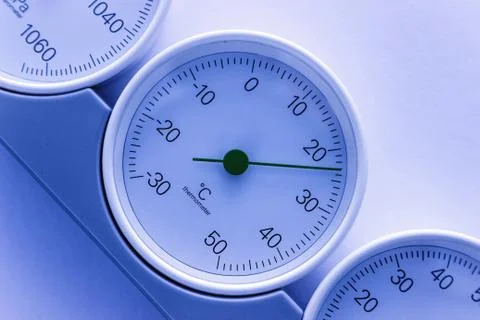 Modern, round barometer, thermometer, hygrometer. Analog device for measuring Stock Photos
