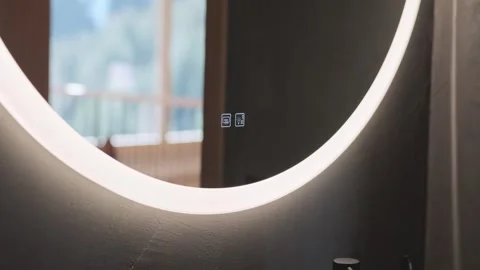 Modern round bathroom mirror with integrated led lighting and smart touch screen 스톡 동영상 334308836