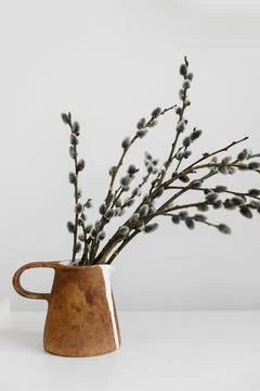 Modern rustic Easter still life. Willow branches in stylish vase on table. .. Stock Photos