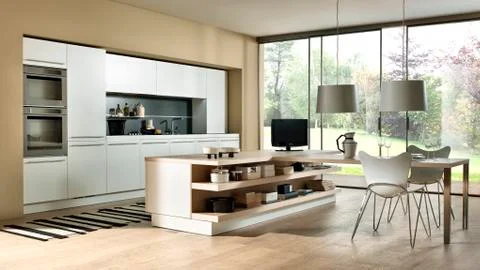 Modern sand colored kitchen with big window and large table Stock Photos