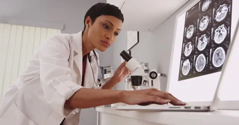 Modern scientist examining with a microscope Stock-Footage 56926754