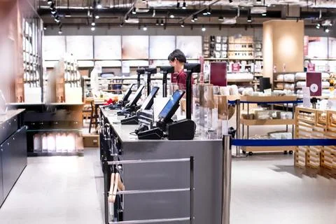 Modern self-checkout counters with digital touch screens and barcode scanne.. Stock Photos