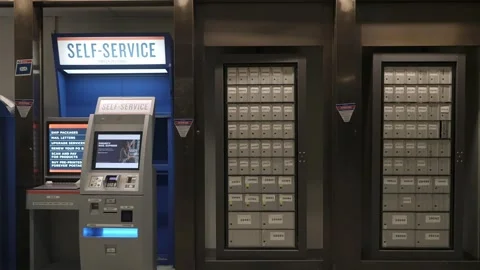 This is a modern selfservice kiosk that includes mailboxes within a public space Vídeo Stock 295073662