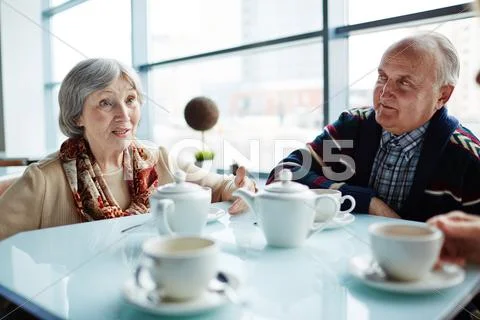 Modern seniors having rest in cafe Stock Photos