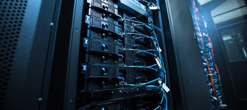 Modern server rack with multiple networked data storage units and cable man.. Stock Photos