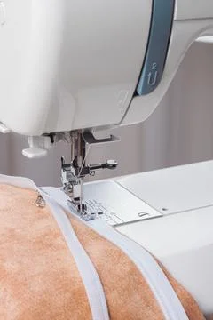 Modern sewing machine special presser foot with beige fabric and zipper, cl.. Stock Photos