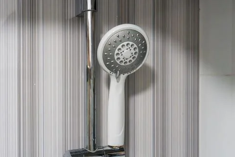 Modern showerhead mounted on sleek chrome pipe Stock Photos