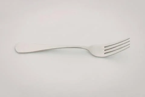 Modern silver fork on clean surface Stock Photos