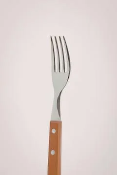 Modern silver fork with orange handle Photos