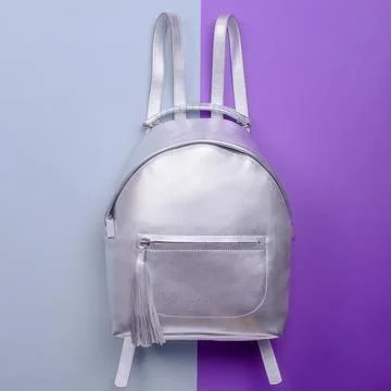 Modern silver metallic leather backpack for women with a handle and a zippe.. Stock Photos