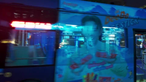 Modern single deck blue bus speeds along Phloen Chit Road Stock Footage 289541593