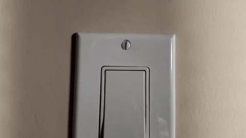 Modern Single Light Switch on Wall with Shadow Detail Stock Footage 263928076