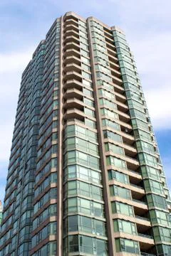 Modern single tower condominium building glass and concrete construction Stock Photos
