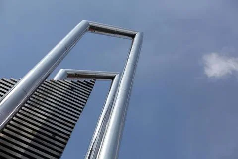 Modern skyscraper building with metal frames and glass Photos