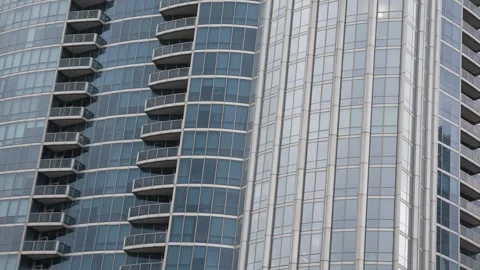 Modern skyscraper exterior with glass windows and balconies Stock Footage 340834535
