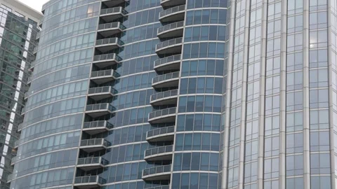 Modern skyscraper exterior with glass windows and balconies Stock Footage 340834640