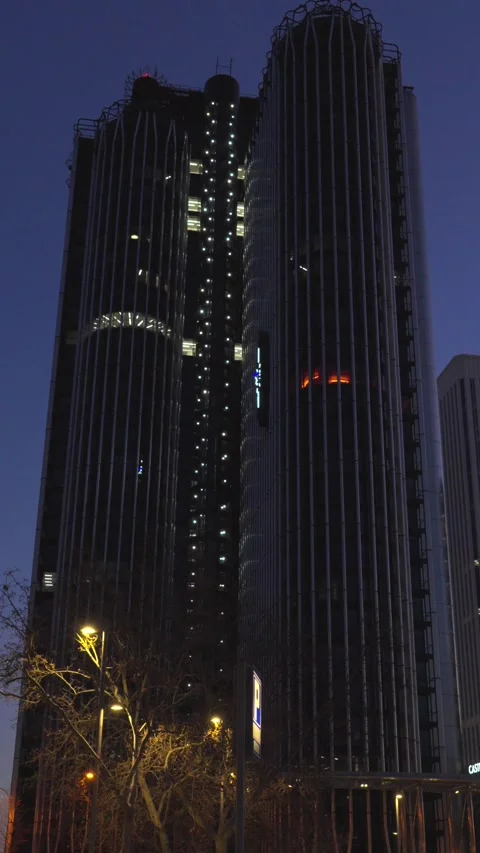 Modern skyscraper facade with moving elevator lights at night Stock-Footage 329592888