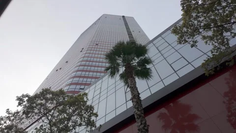 Modern skyscraper with glass facade reflecting the sky Видео 337645871