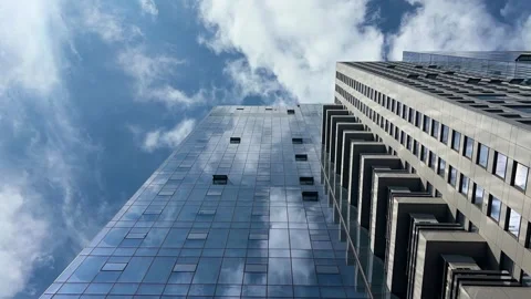 Modern skyscraper glass facade reflecting clouds Видео 343067056