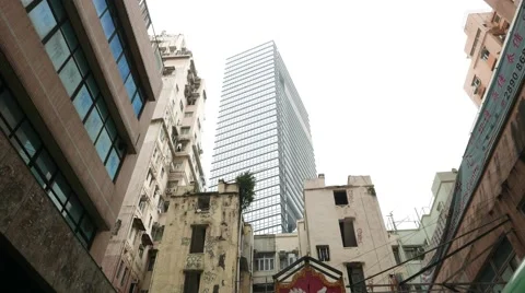 Modern skyscraper hide behind outdated abandoned ragged house, dolly shot 스톡 동영상 55708687
