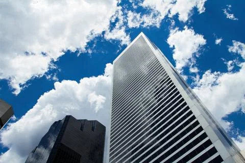 Modern Skyscraper Looking Up with Dramatic Clouds and Blue Sky Stock Photos