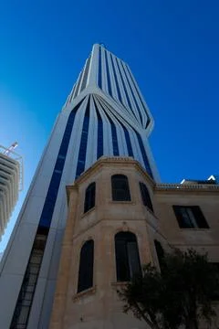 Modern skyscraper reaching for the vibrant blue sky in Malta 库存照片