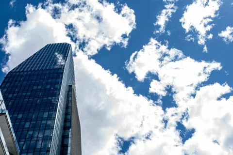 Modern skyscraper with reflections of clouds on windows Stock Photos