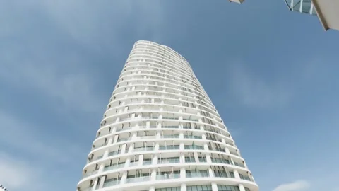Modern skyscraper rises against a clear blue sky Stock Footage 302351338