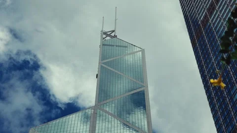 A modern skyscraper rises majestically into the vibrant Hong Kong skyline, Stock Footage 338311530