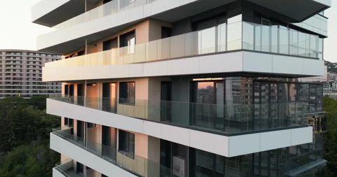Modern skyscraper sharp angles glass walls capturing urban reflections aerial Stock Footage 301874063
